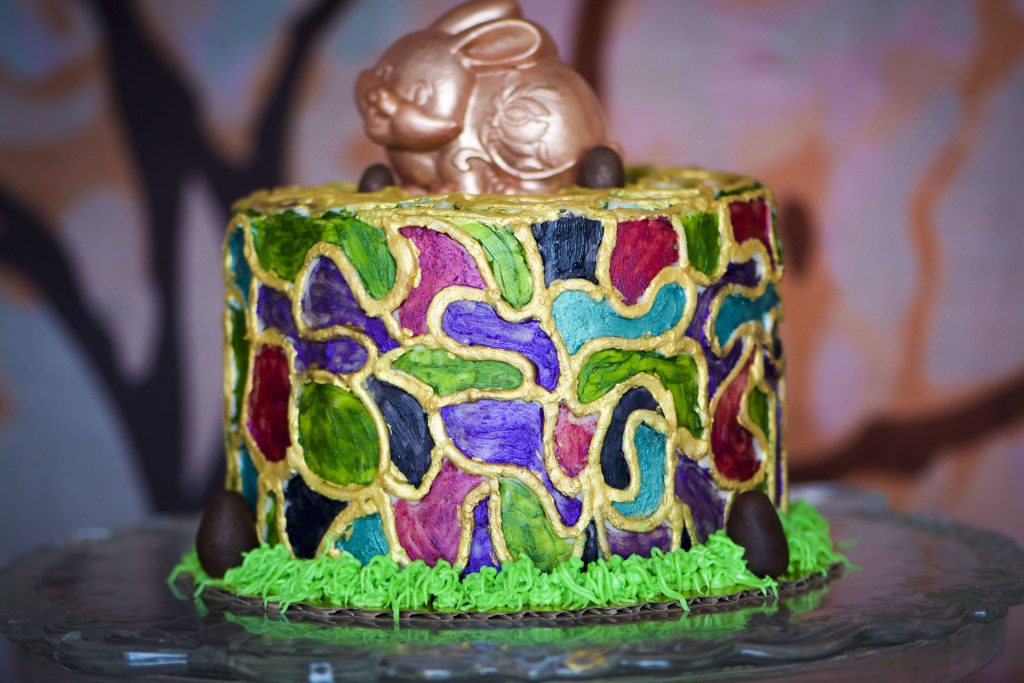 Cake decorated with handpainted mosaic collar, topped with edible chocolate bunny.