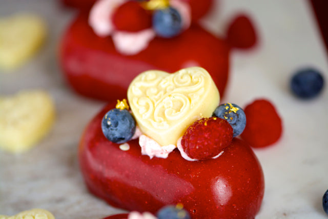 Individual Cake with white chocolate heart decoration and fresh fruits.