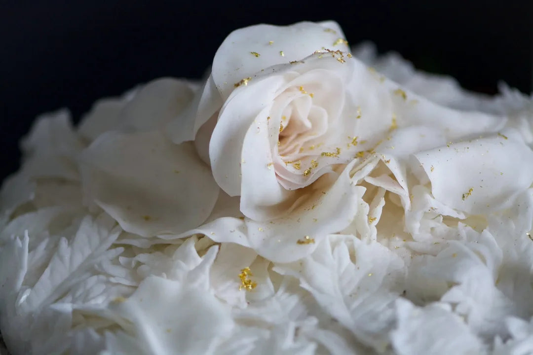 Close-up image of a Chipper & Cheeky gluten-free cake with a winter white rose for a wedding in Valencia, CA.