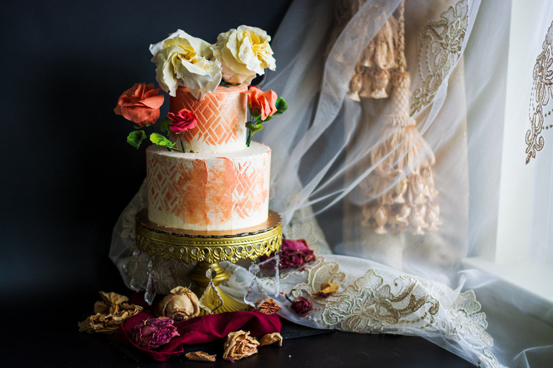 Close-up photograph of a Chipper & Cheeky romantic gluten-free wedding cake canvas adorned with delicate, sugar rose flower decorations for a luxury celiac-safe private event in Los Angeles.