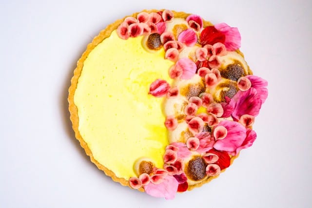 A bright image of a gluten-free lemon tart with floral sugar petals for a family friend in Beverly Hills.